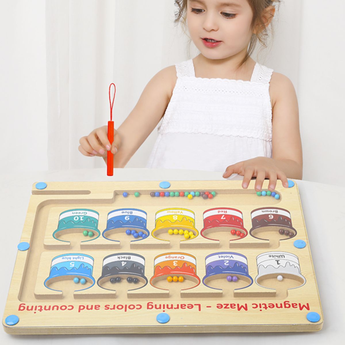 The wooden toy for learning fine motor skills is a magnetic maze designed for colors and numbers, suitable for young children and preschoolers.