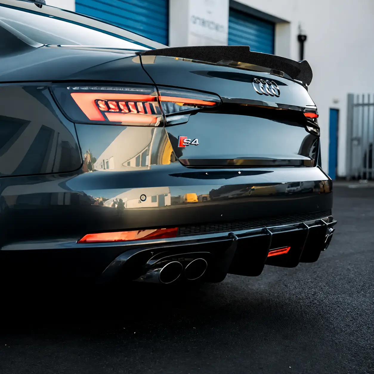 Close up rear angle of an Audi A4 S4 sedan with a high kick real carbon fiber rear spoiler installed