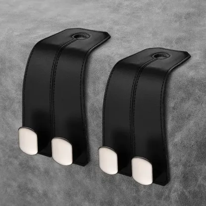 One pair of classic black car headrest hooks installed in an Audi interior