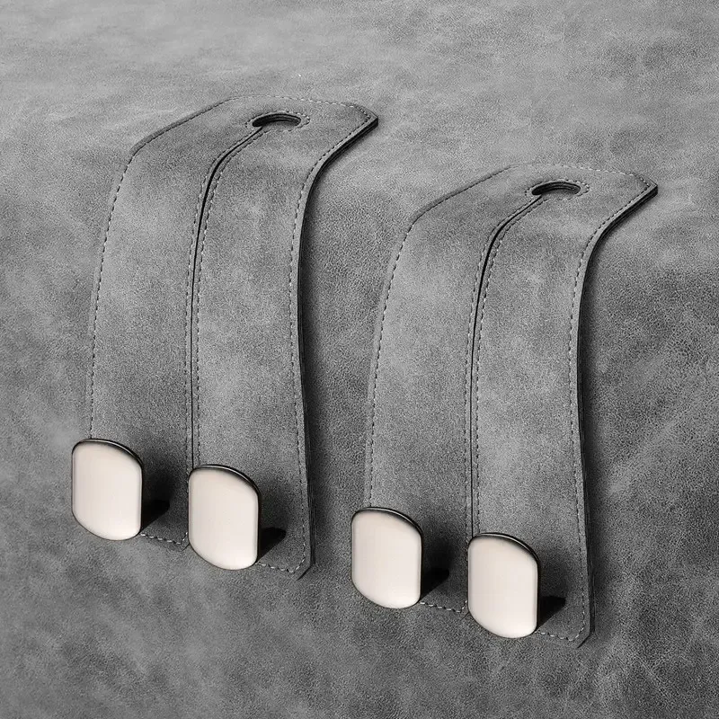 Pair of graphite grey backseat storage hooks for luxury vehicle interior organization