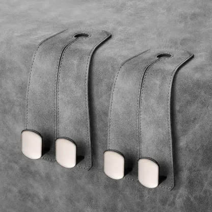 Pair of graphite grey backseat storage hooks for luxury vehicle interior organization