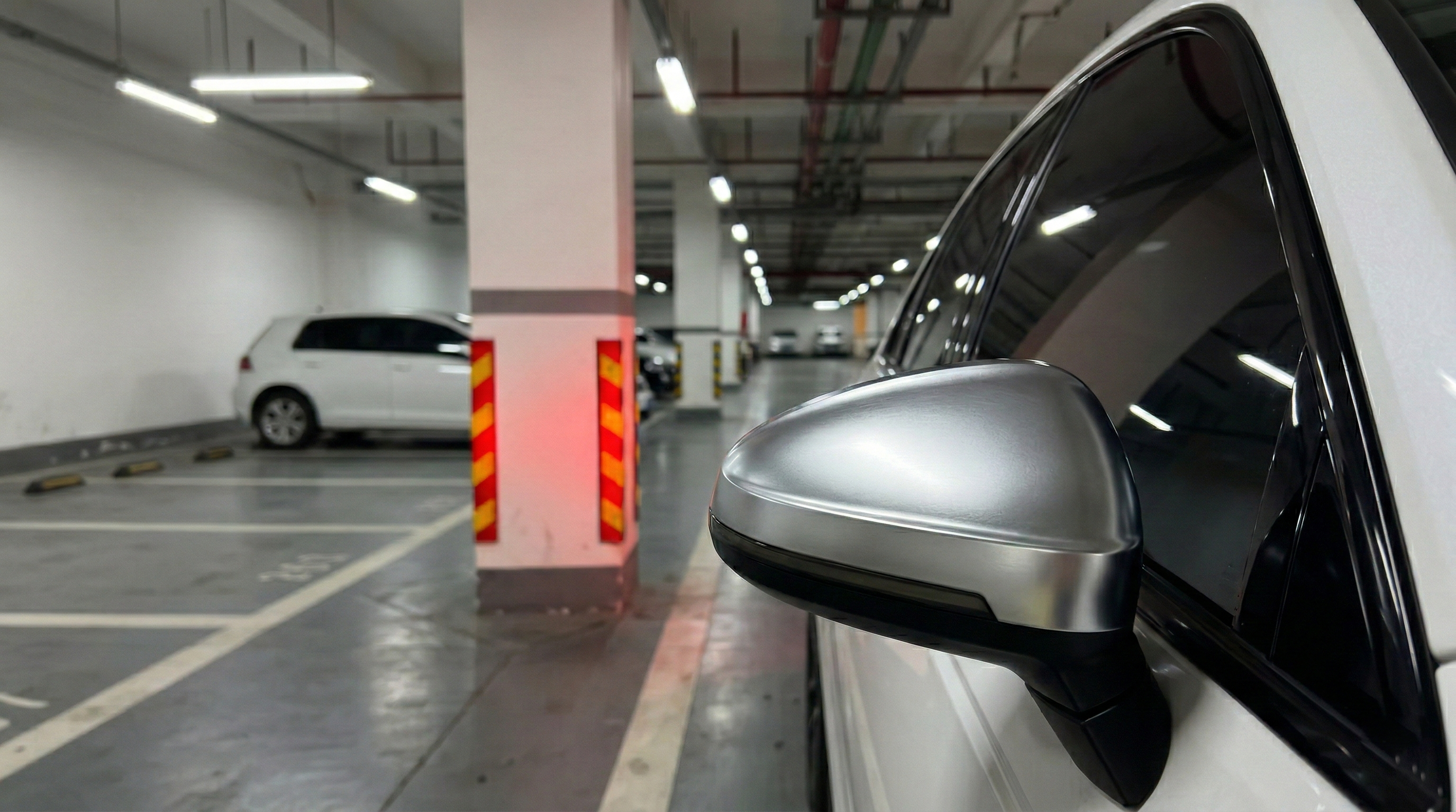 Premium silver aftermarket side mirror cover installed on a white car, highlighting exterior auto parts upgrade.