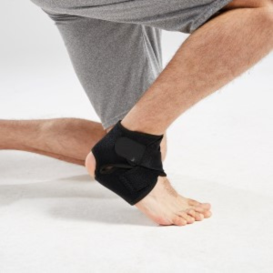 Man kneeling on ground wearing the brace