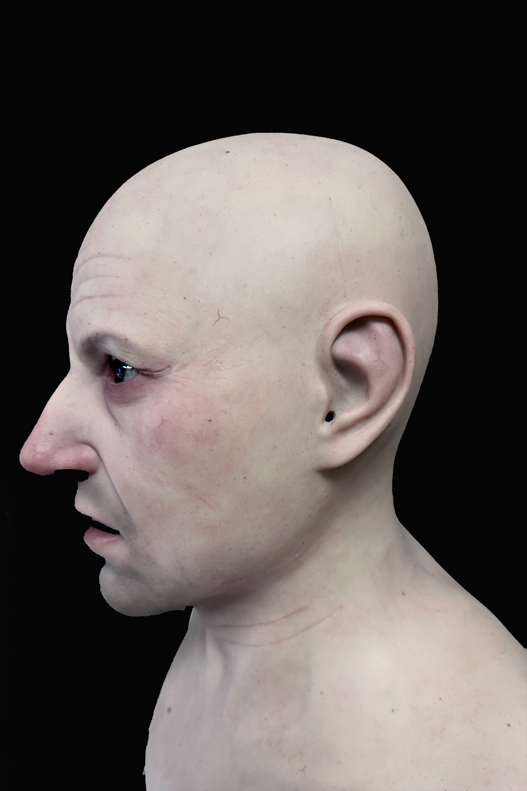Bald elderly man silicone mask with realistic wrinkles and pale skin tone