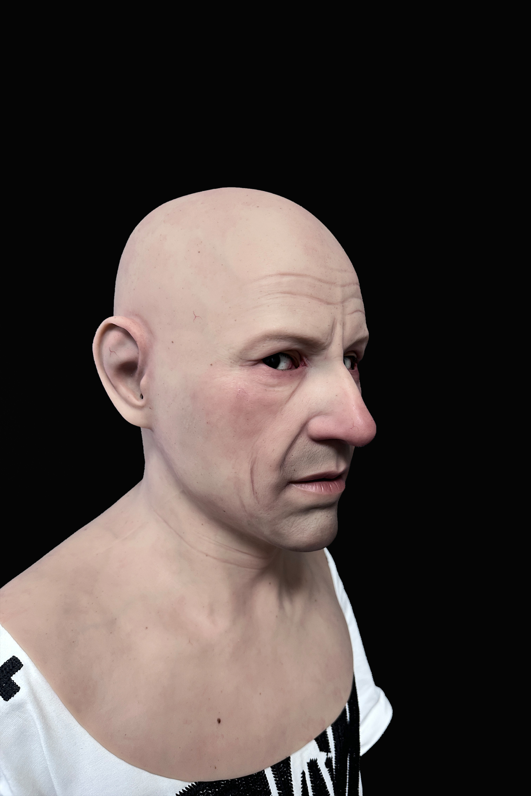 Bald elderly man silicone mask with realistic wrinkles and pale skin tone