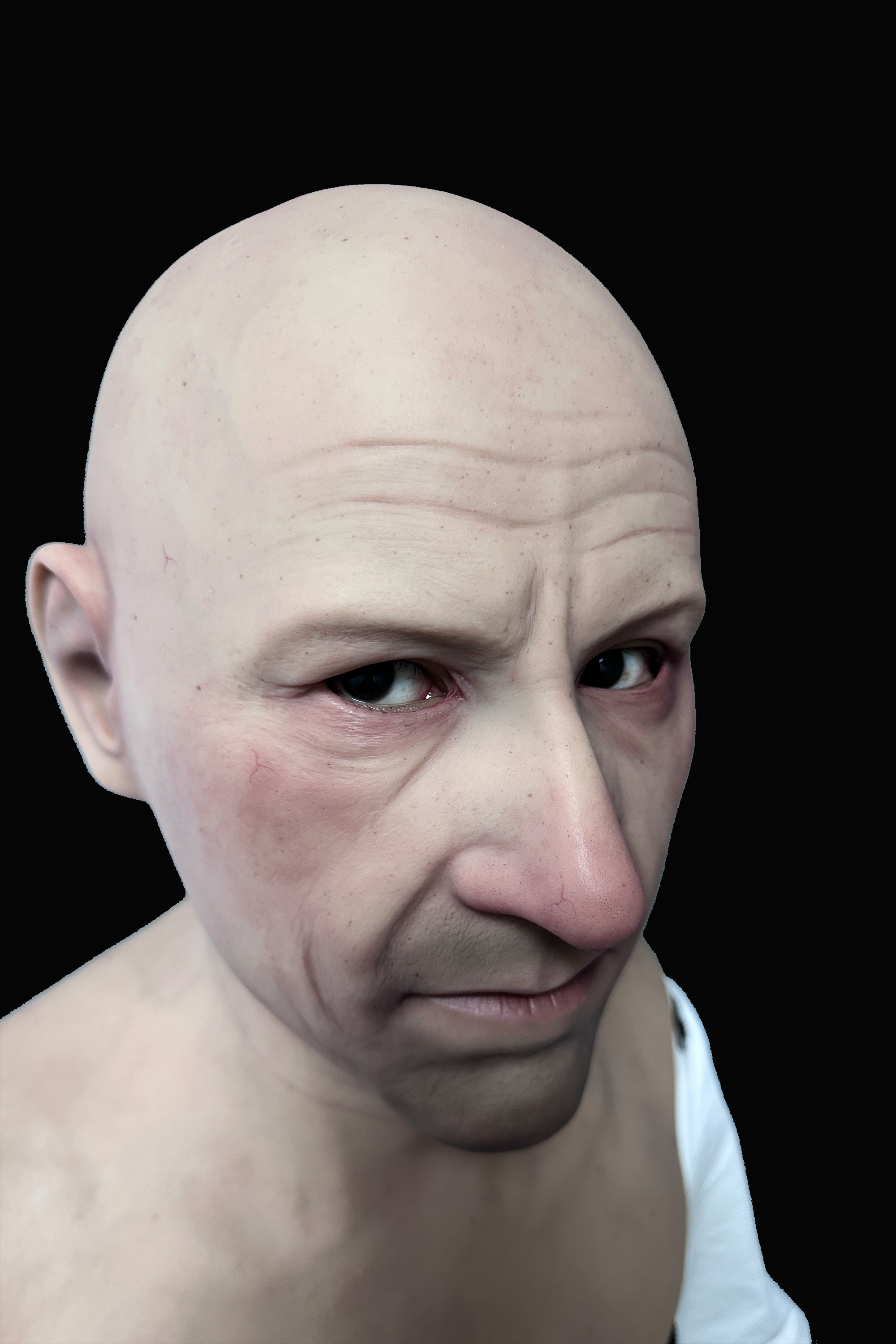 Bald elderly man silicone mask with realistic wrinkles and pale skin tone