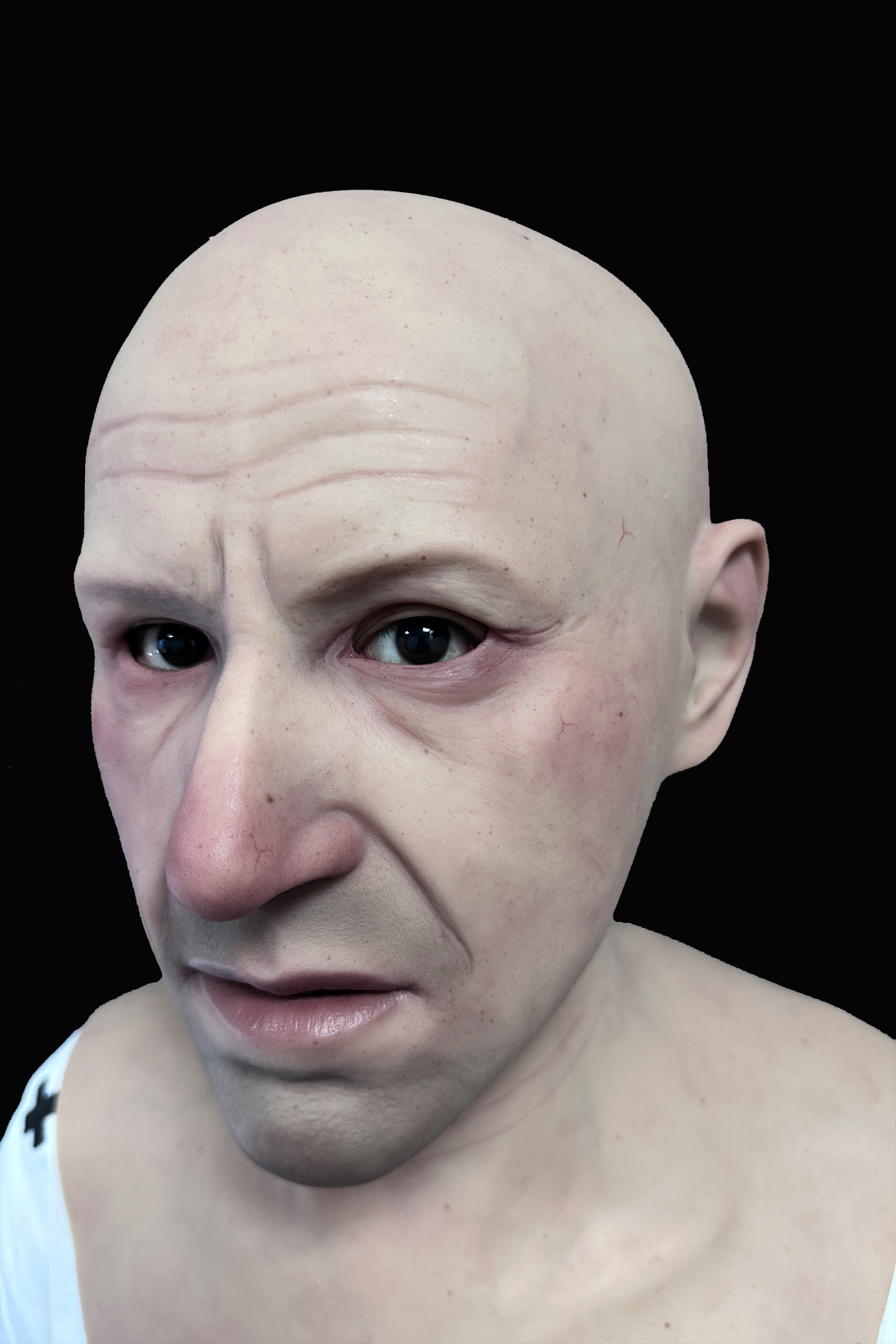 Bald elderly man silicone mask with realistic wrinkles and pale skin tone