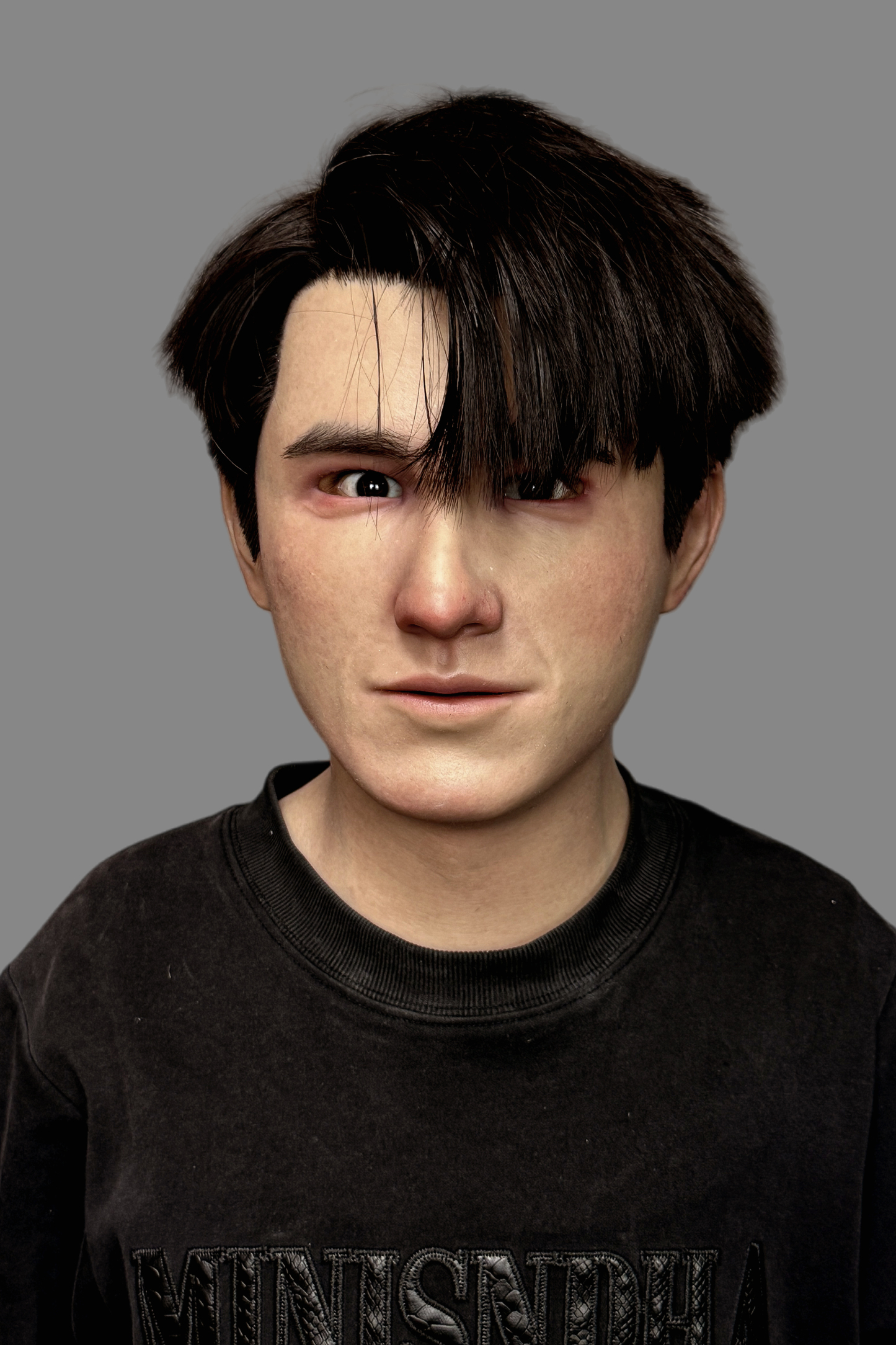 Professional hyper-realistic Asian young man silicone mask with implanted real hair and lifelike skin details, front view.