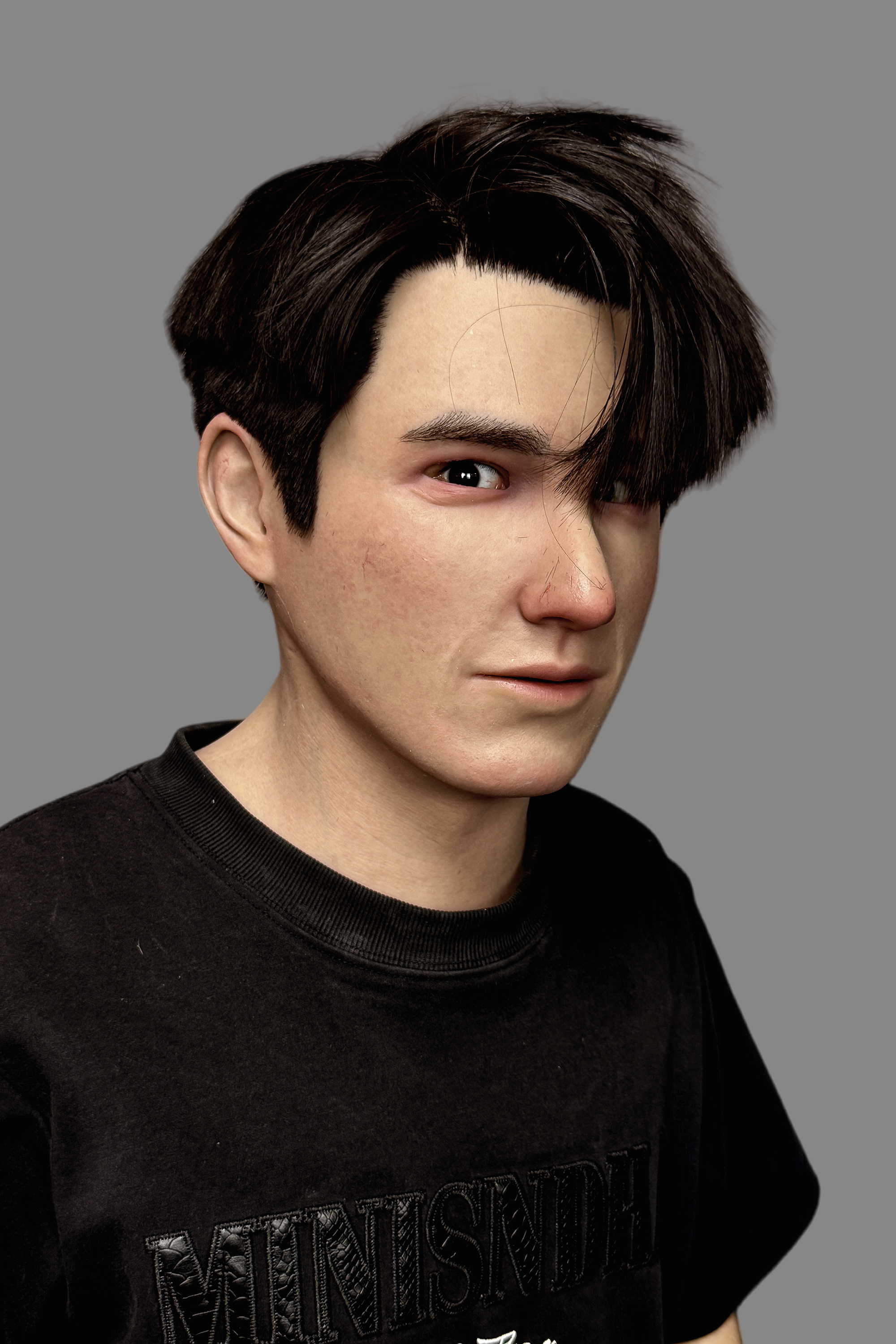 Close-up side view of realistic silicone Asian male mask highlighting hand-punched hairline, ear details, and pore texture.