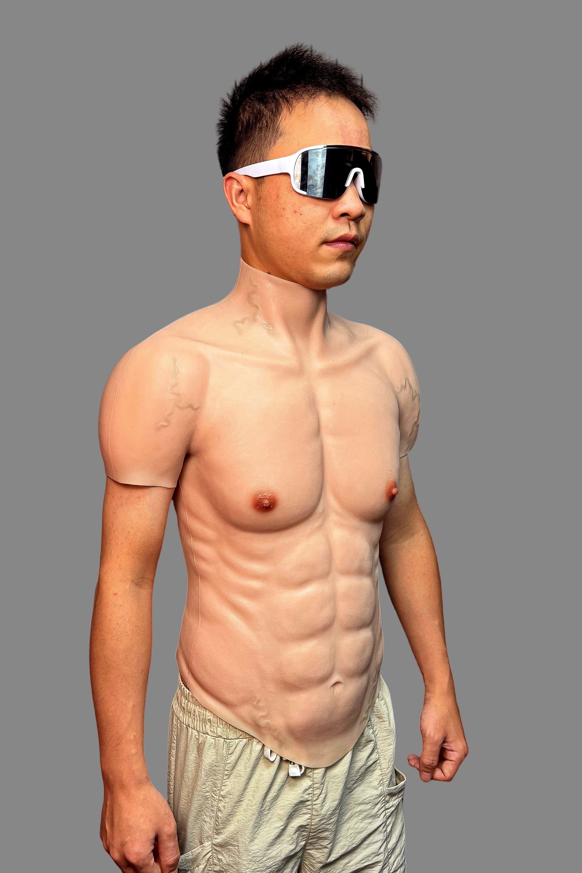 Silicone muscle bodysuit with full back zipper from neck to waist, realistic skin texture and muscle definition, rear view.