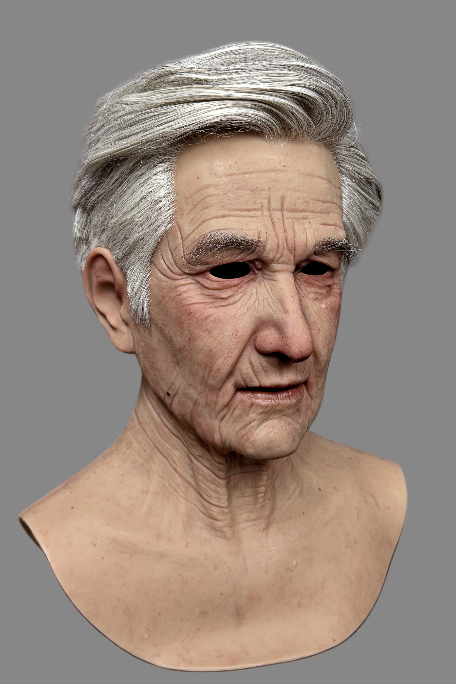 Premium realistic elderly male silicone mask highlighting detailed ear structure, natural hairline, and aged skin texture, left side view.
