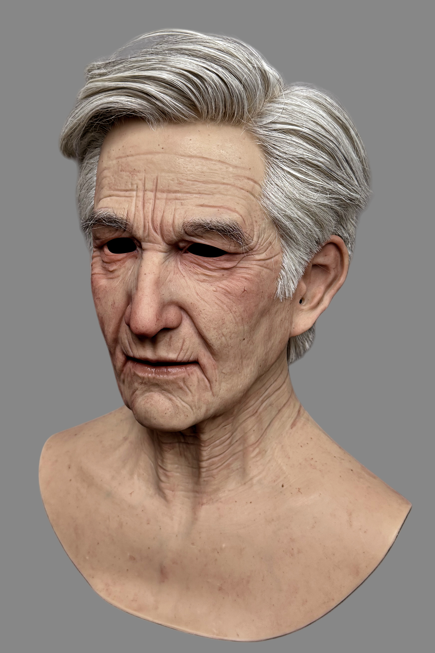 Hyper-realistic old man silicone mask with platinum silicone skin, visible veins, and authentic gray hairstyle, three-quarter right angle.