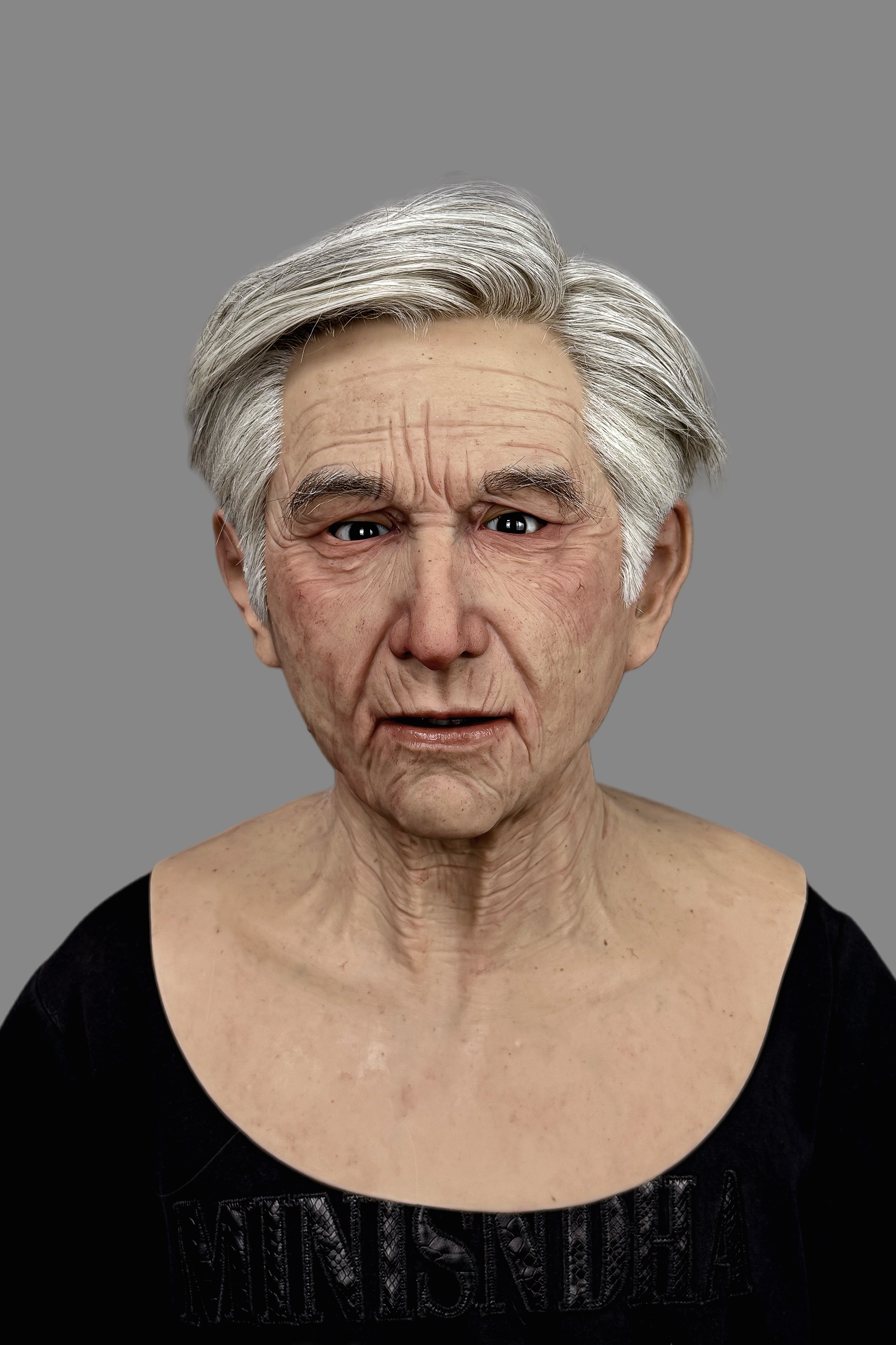 Lifelike senior Caucasian male full-face silicone mask showing natural expression, deep forehead lines, and realistic neck wrinkles.
