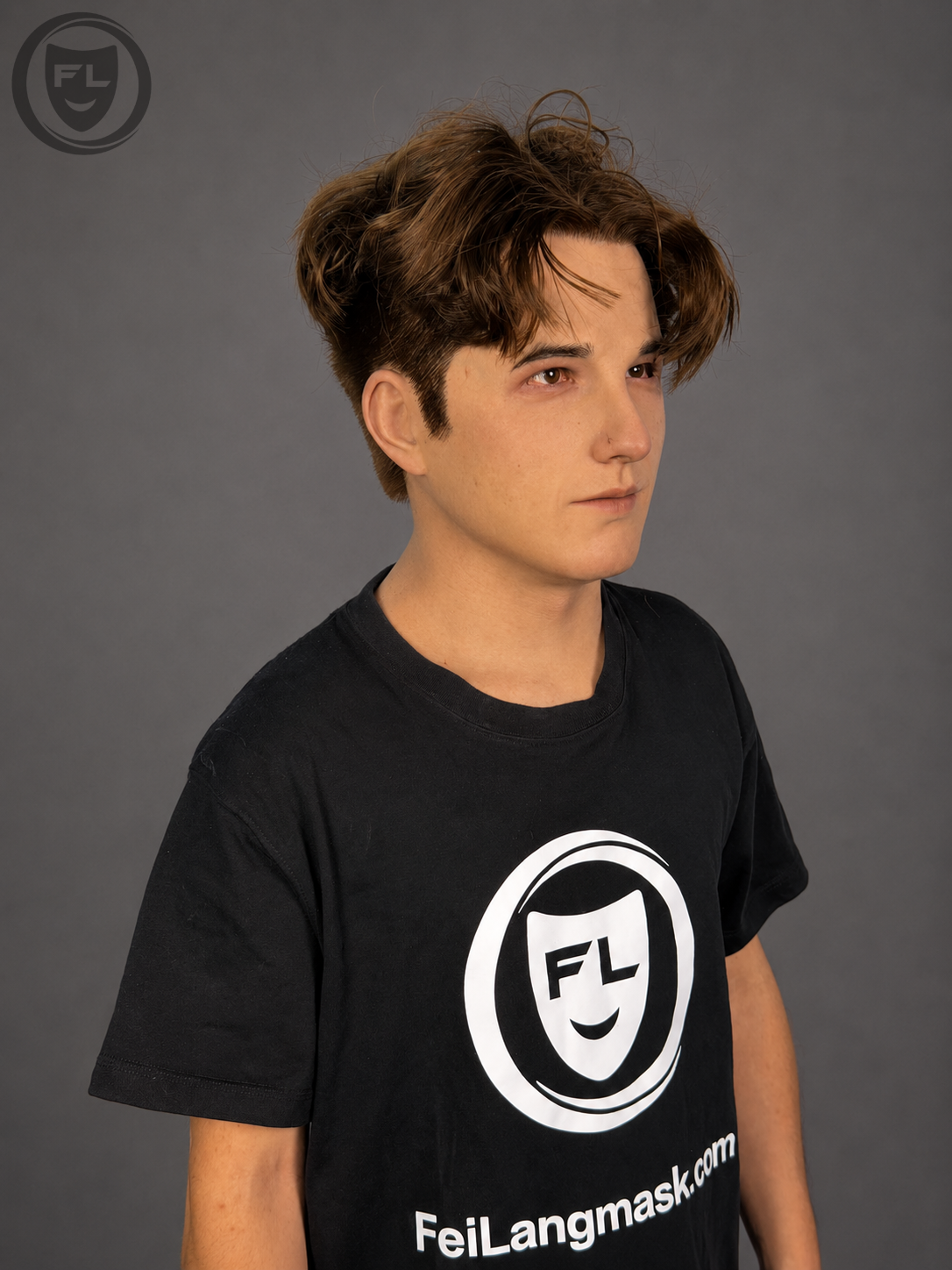 Young male silicone mask with textured brown hair worn from side
