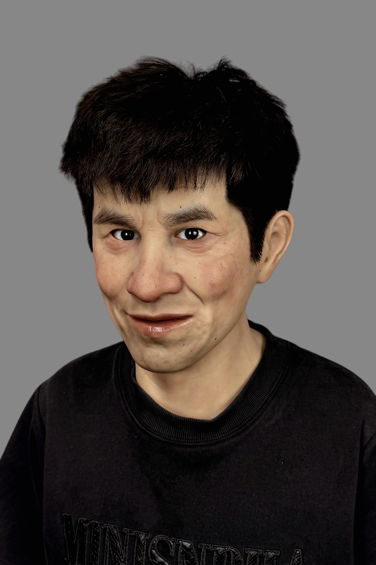 Ultra-lifelike young man silicone mask featuring realistic teeth, natural skin texture and awkward grin, front view on model