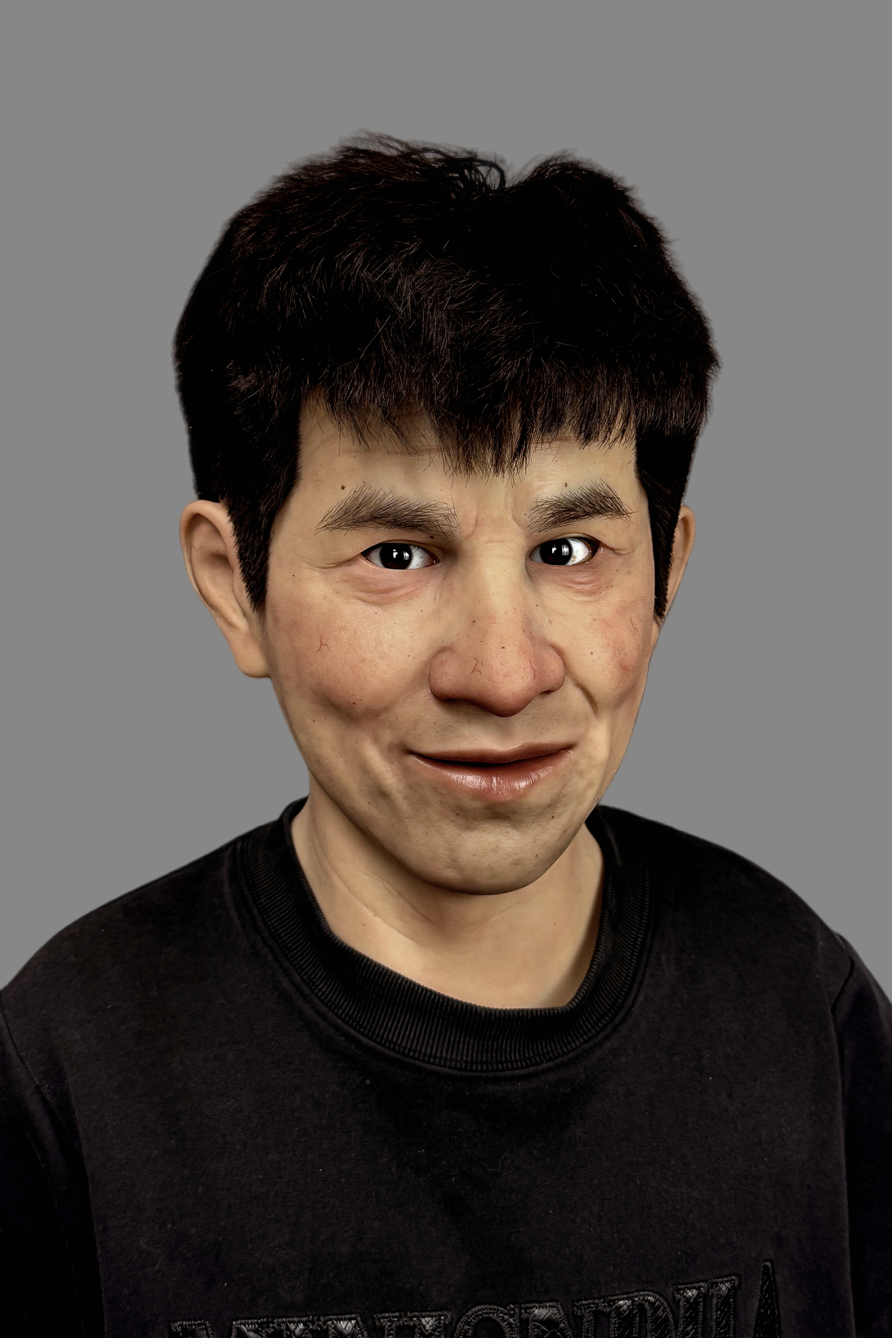 Professional-grade realistic guy silicone mask with short black hair, visible pores and humorous facial expression, front angle.