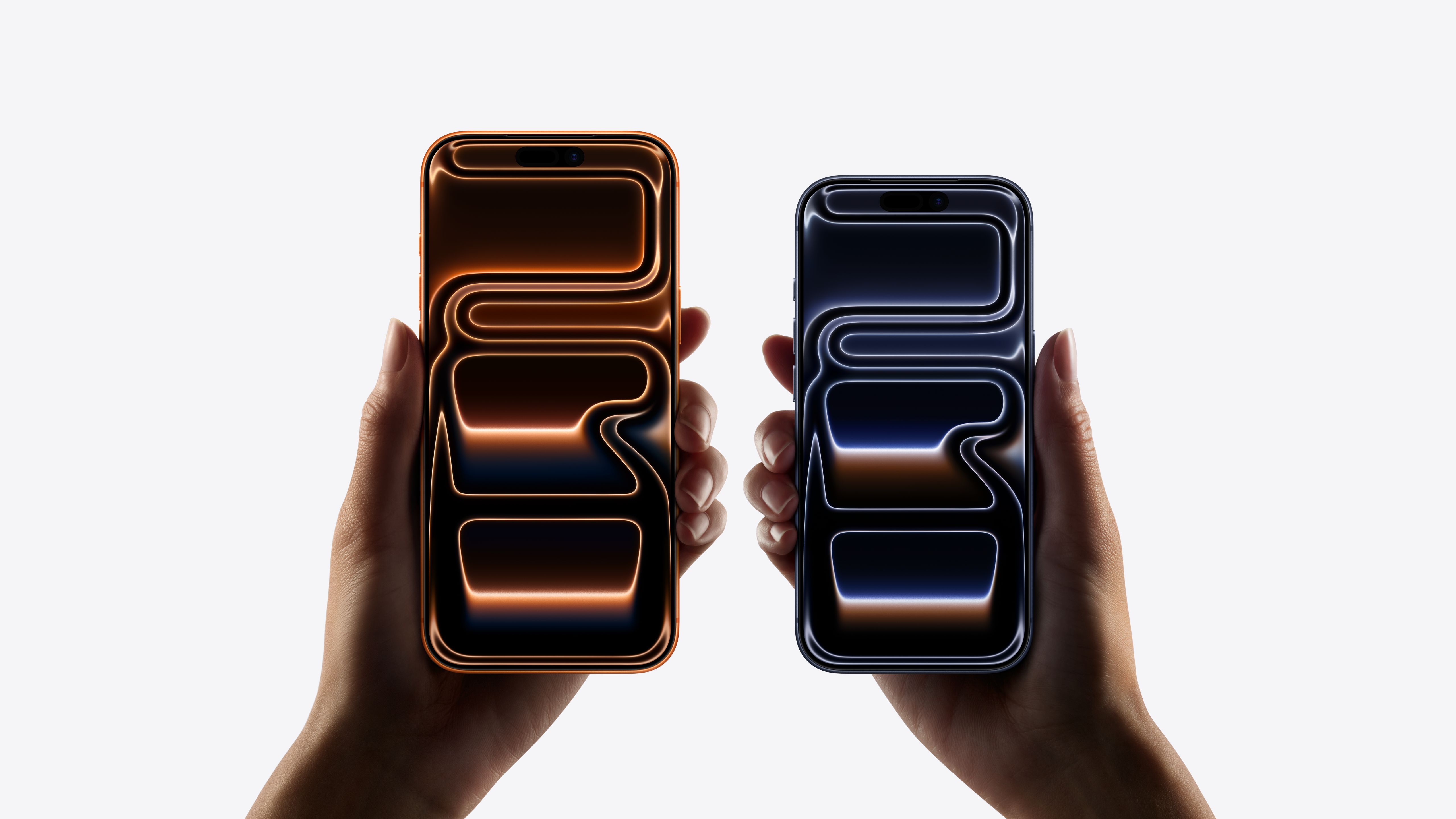 Two models, iPhone 17 Pro Max, iPhone 17 Pro, a hand holds each model, iPhone 17 Pro Max is taller and wider in the hand than iPhone 17 Pro, all screen display, rounded corners