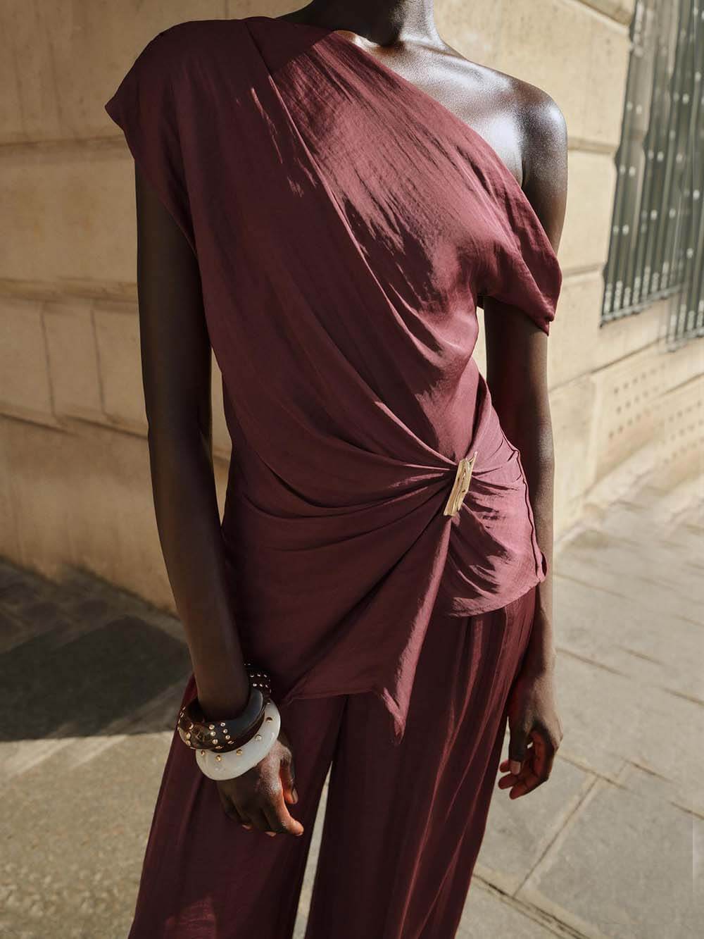 Unique Asymmetric Hem Metallic Accents Top