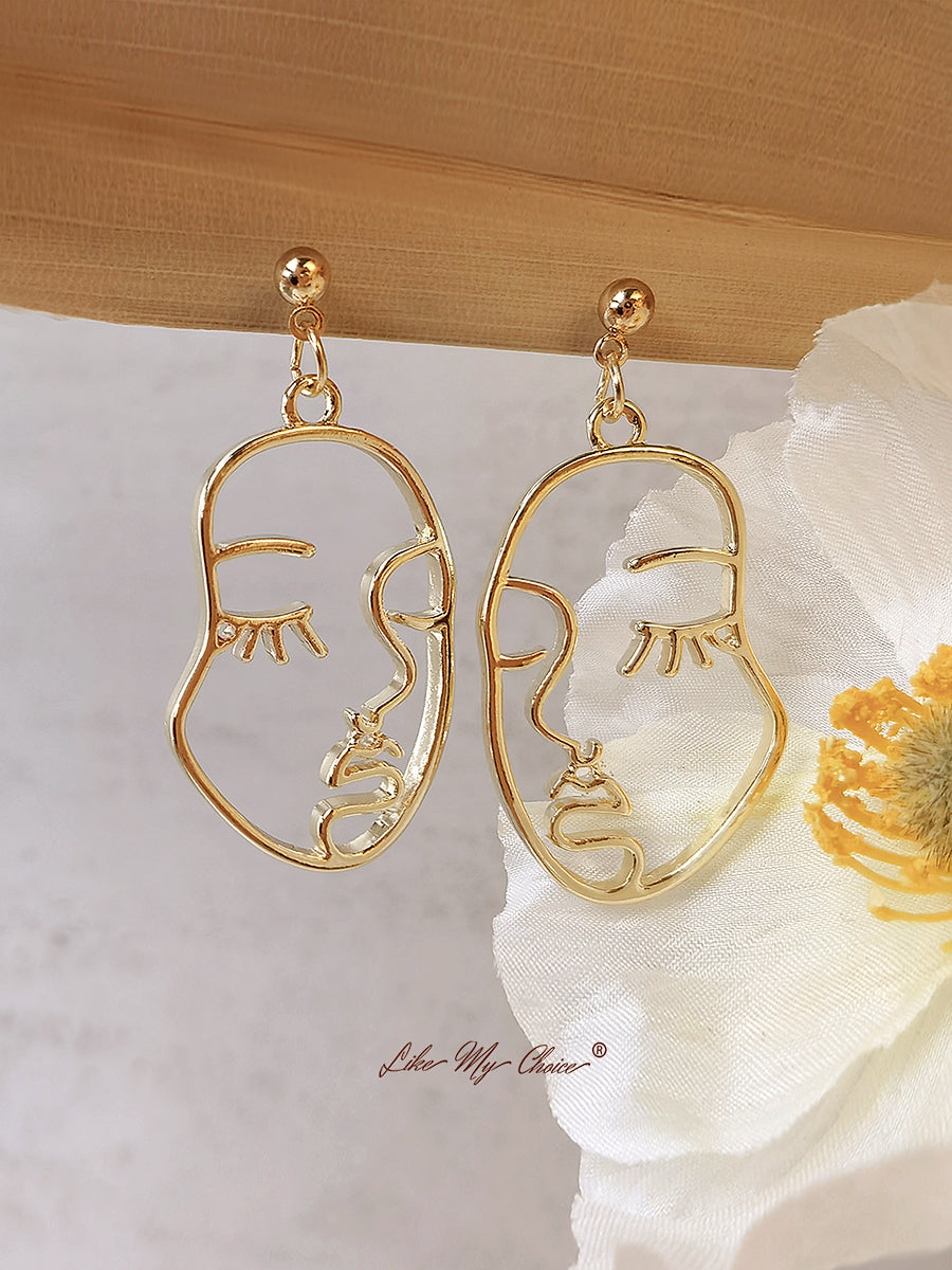 Pendientes colgantes modernos con rostro humano abstracto