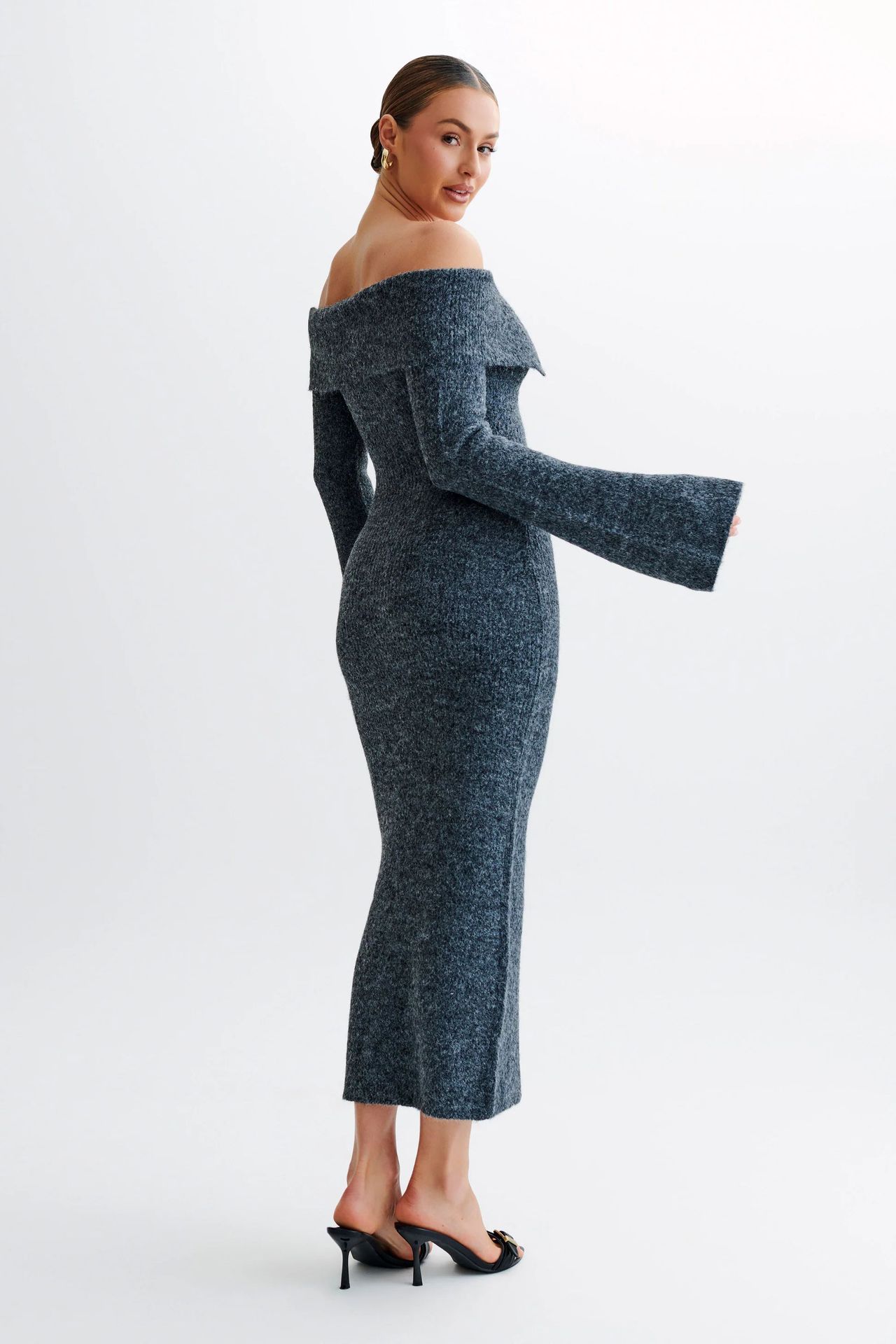 Off-the-shoulder knitted sweater dress, form-fitting, hip-hugging style.