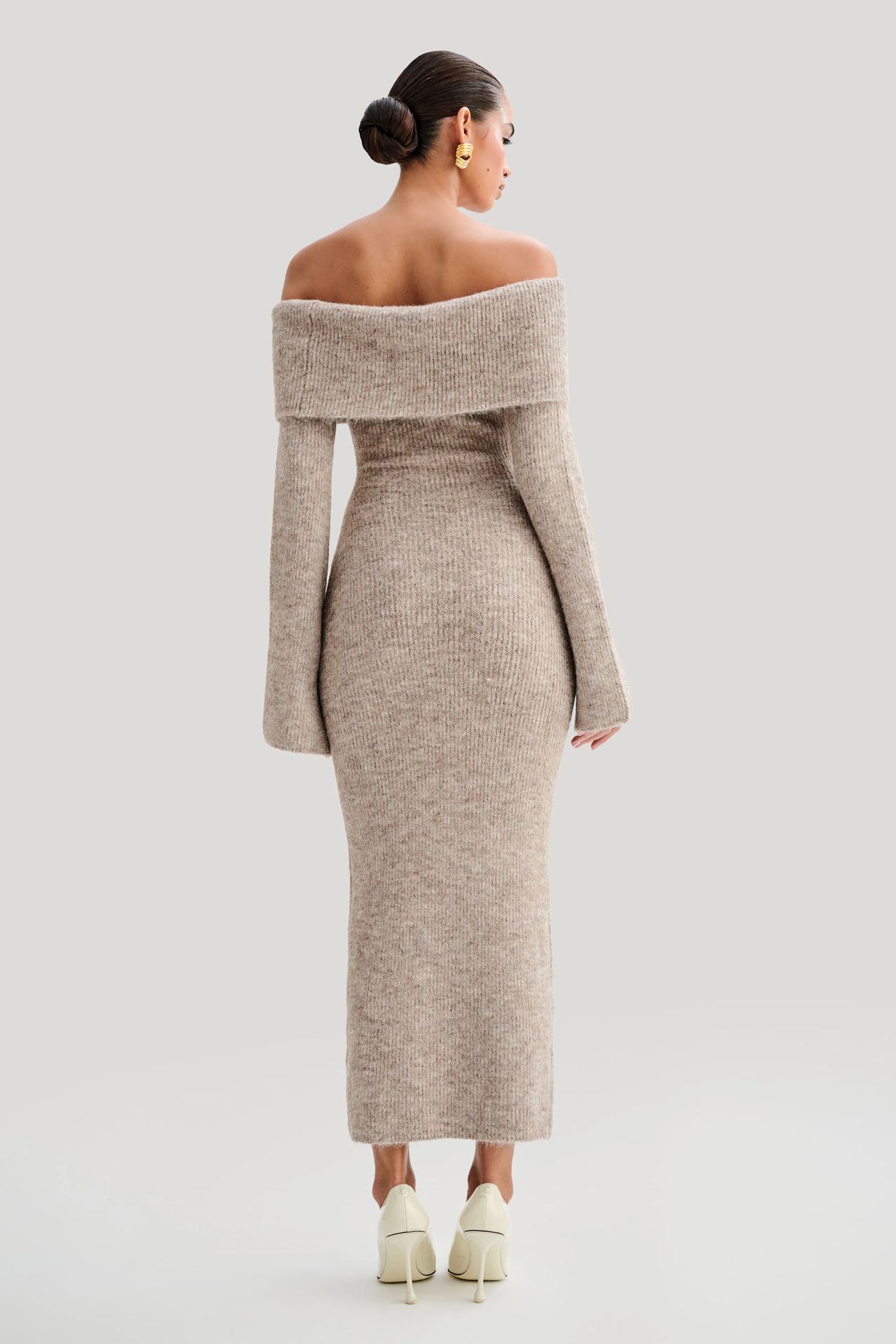 Off-the-shoulder knitted sweater dress, form-fitting, hip-hugging style.