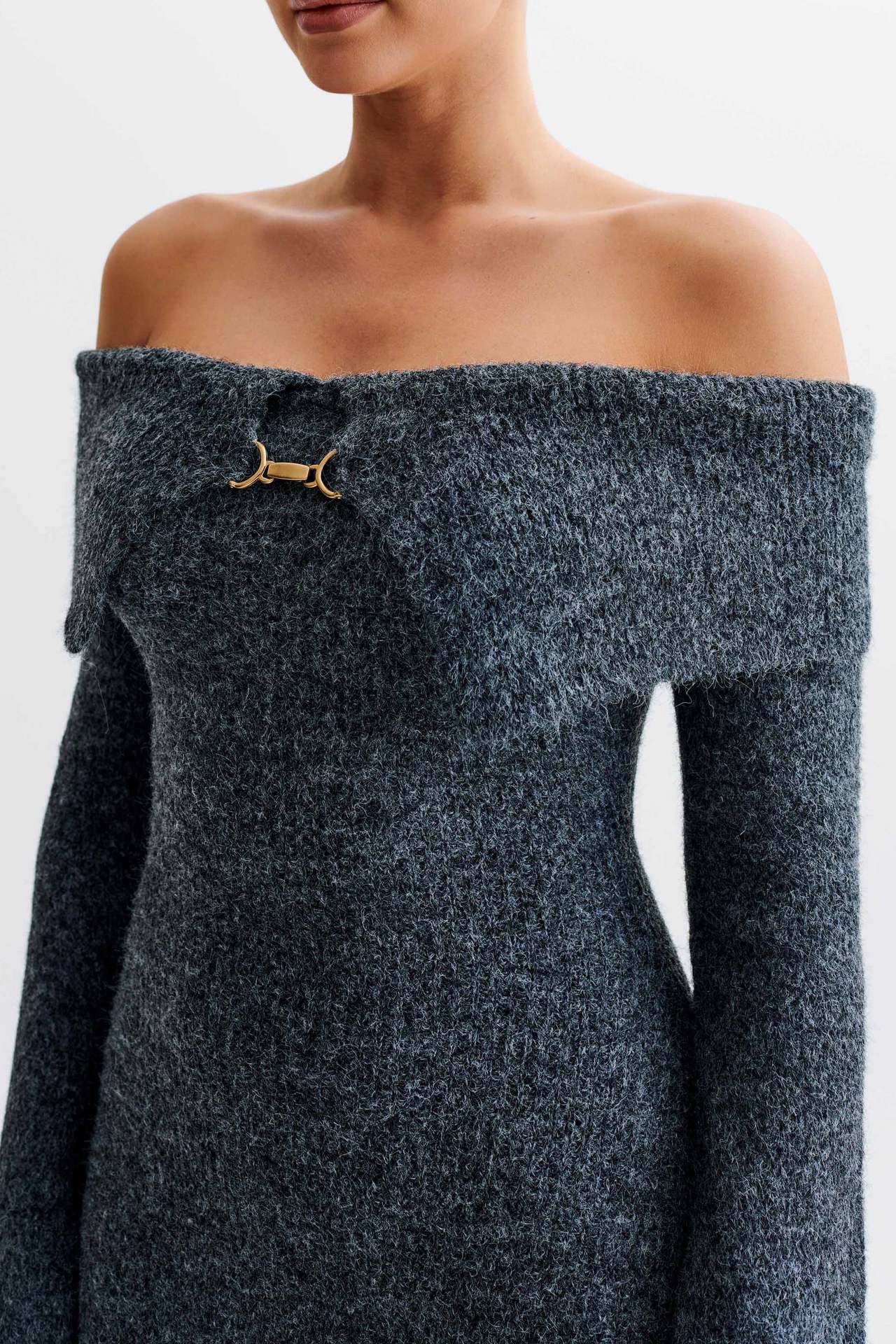 Off-the-shoulder knitted sweater dress, form-fitting, hip-hugging style.