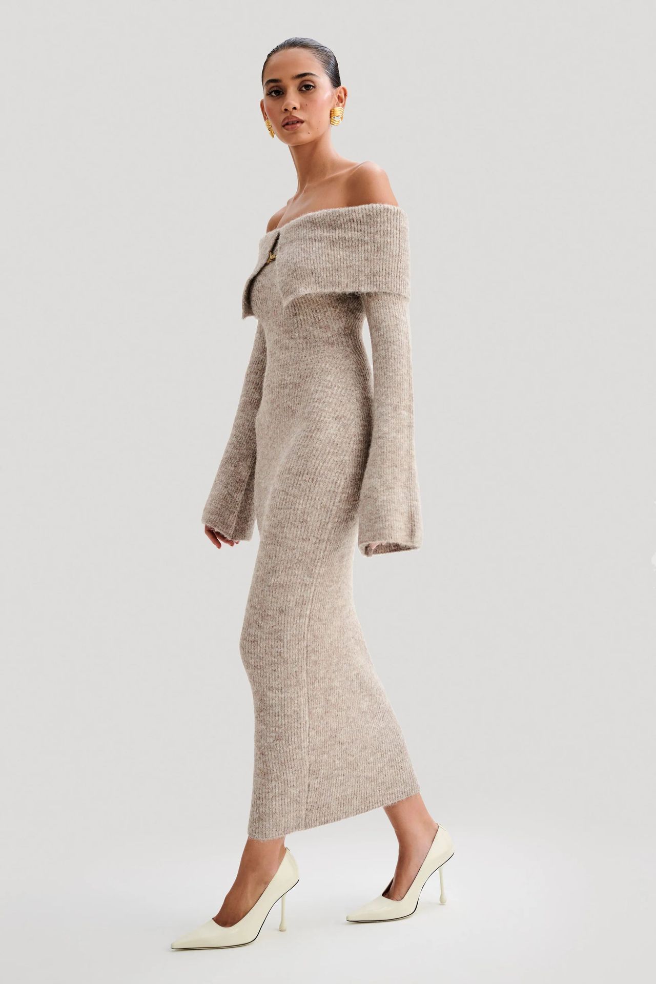 Off-the-shoulder knitted sweater dress, form-fitting, hip-hugging style.