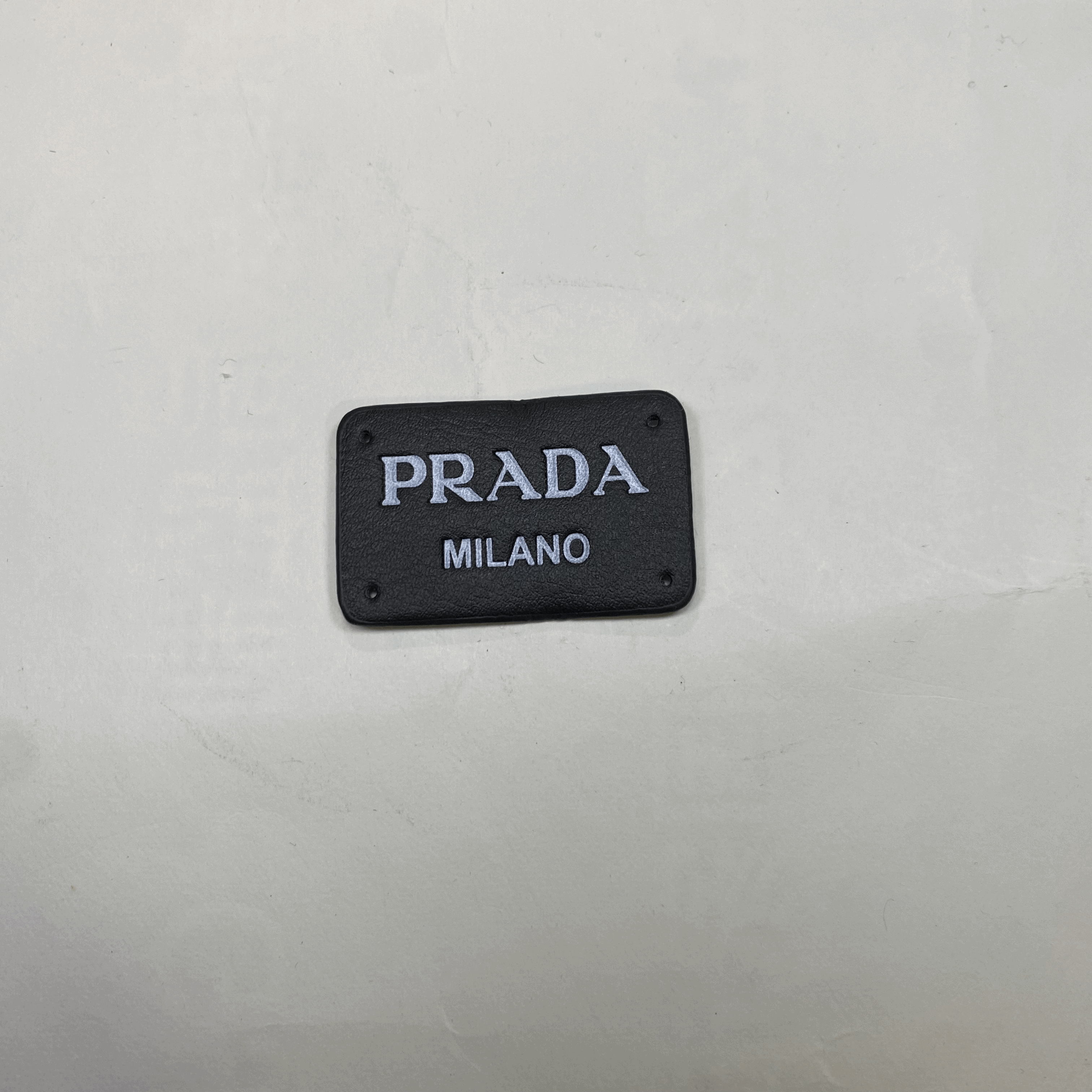medium and small (roning & sewing) Prada patch 1