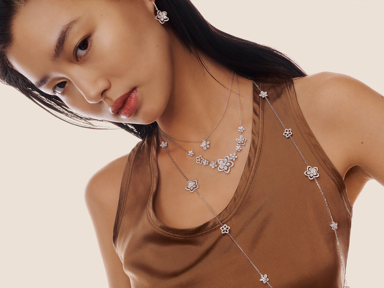 Model wearing Grthtaff Wild Flower jewellery collection diamond bracelets and bangles