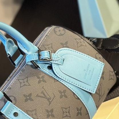 LV KEEPALL BANDOULIÈRE 25 MONOGRAM ECLIPSE REVERSE COATED CANVAS TURQUOISE 25CM M11645