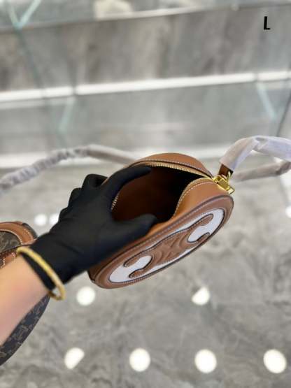 CE OVAL BAG CUIR TRIOMPHE IN TEXTILE AND CALFSKIN NATURAL 20CM