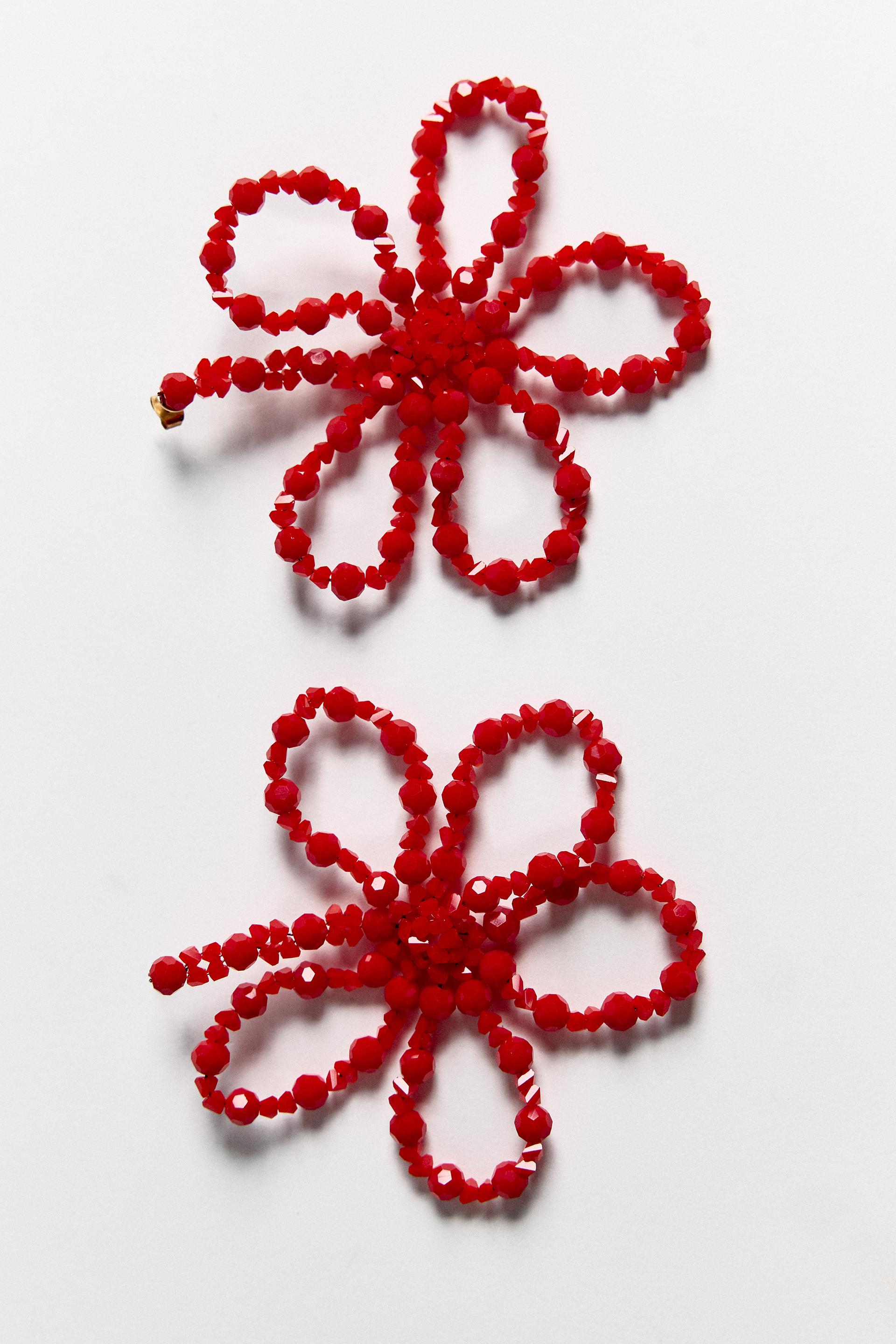Flower shaped metal drop earrings with colorful bead appliqu. Butterfly closure.