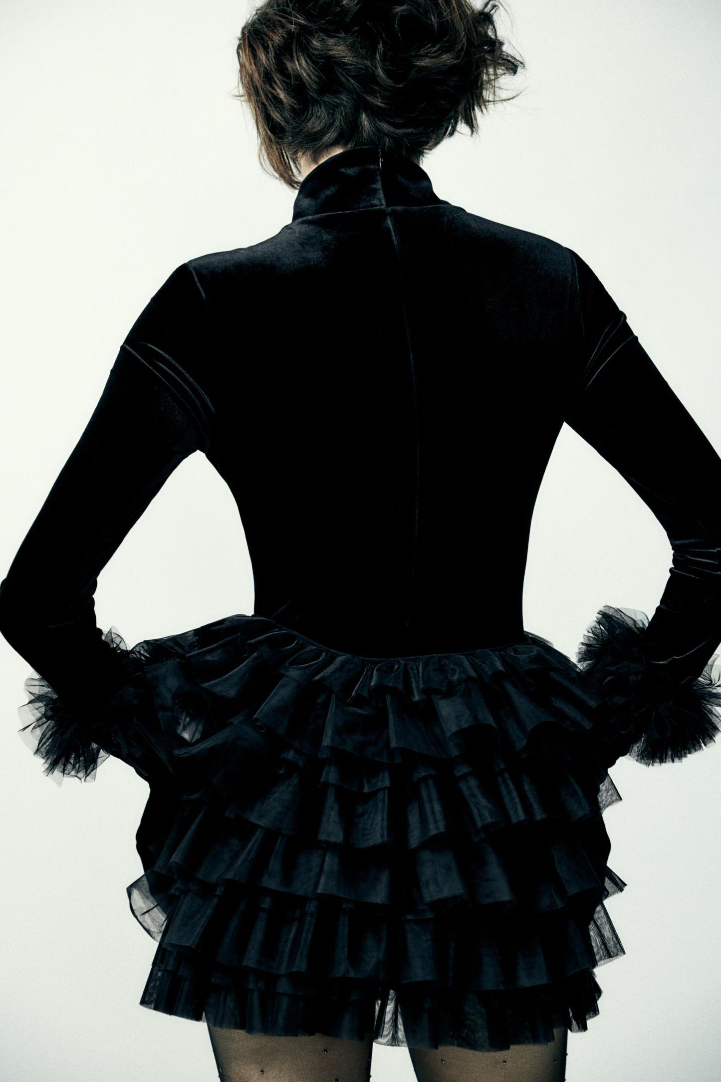 Mini skirt with a mid elastic waistband. Tulle ruffle details. Matching interior lining.