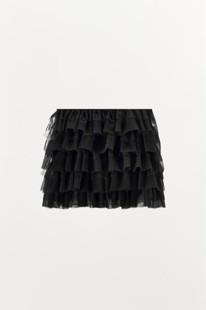 Mini skirt with a mid elastic waistband. Tulle ruffle details. Matching interior lining.