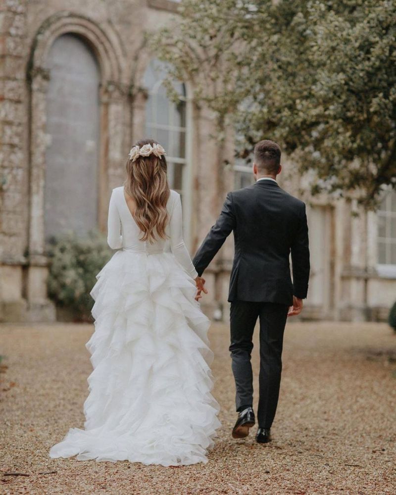Long sleeves low back white ruffles wedding dress with court train