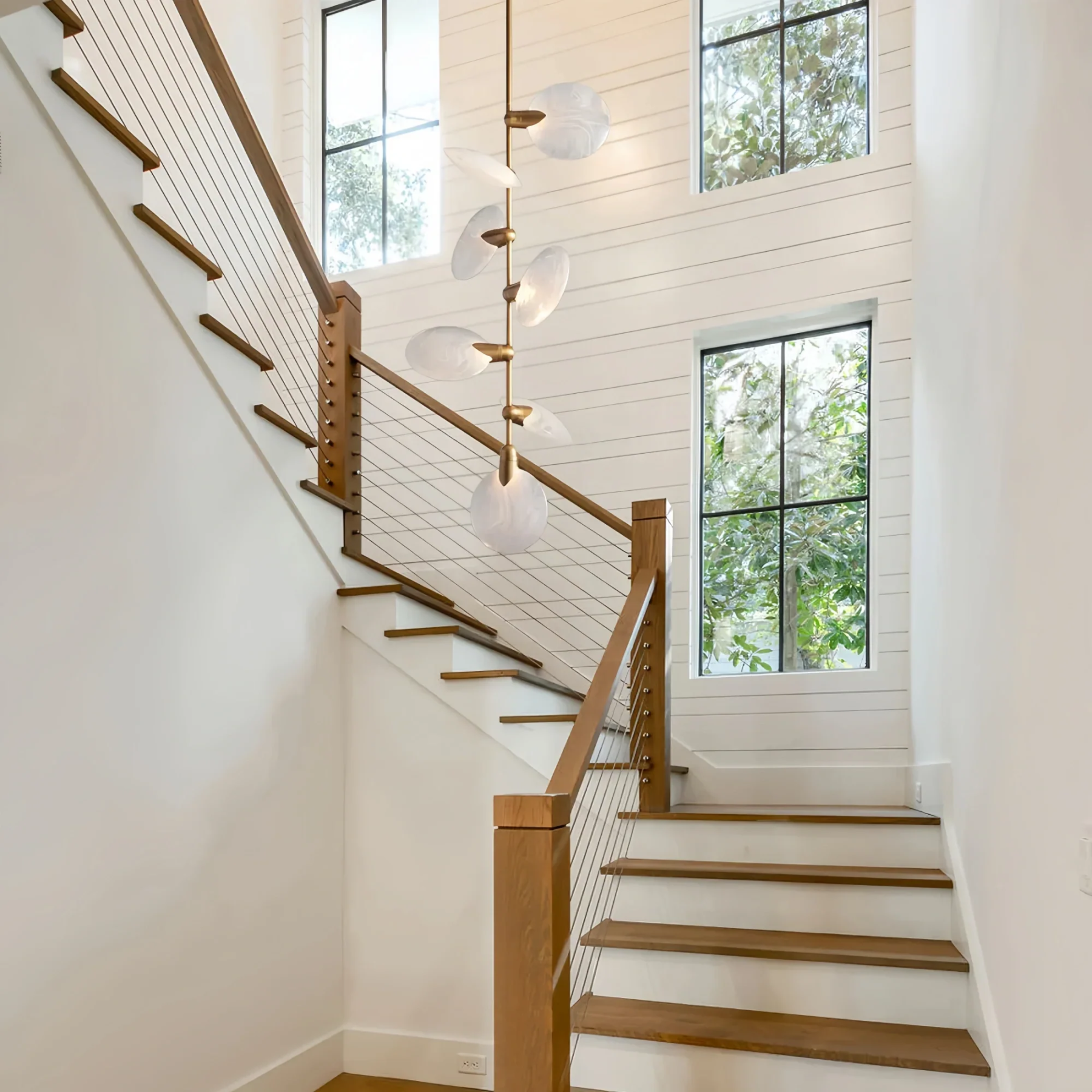 Modern staircase pendant lighting featuring Lyla Pendant in brushed brass