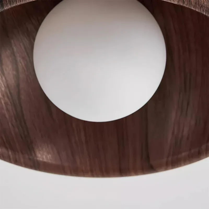 Close-up of Muto wood ceiling light's bulb, wood grain details