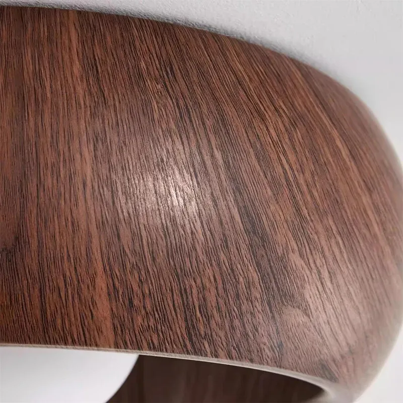 Close-up of Muto wood ceiling light fixture, wood grain detail.