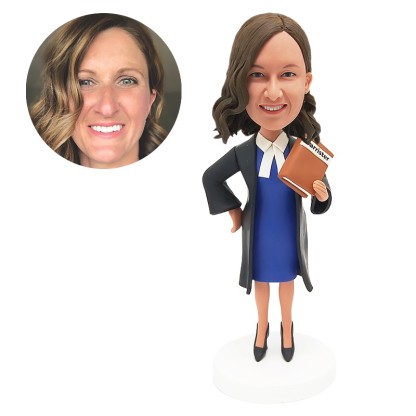 bobble head figurine lawyer holding a book