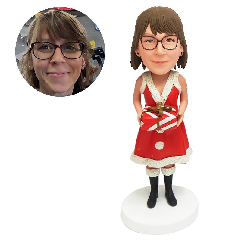 bobble head figurine christmas lady holding a gift