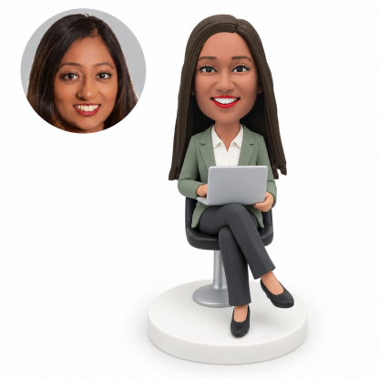 custom bobblehead figure businesswoman seated with crossed legs holding an open laptop on her lap with both hands