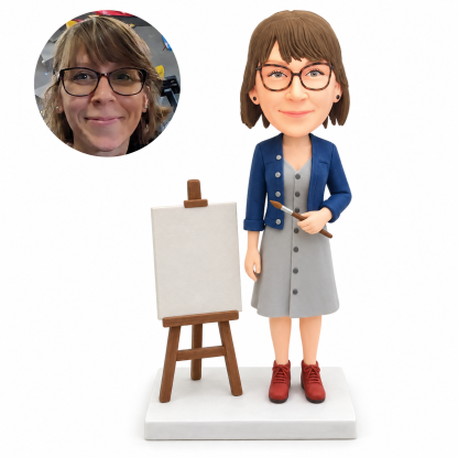 custom bobblehead figure female art teacher in a dress holding a paintbrush beside an easel