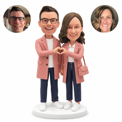 custom bobblehead figures couple in long coats making a heart with their hands