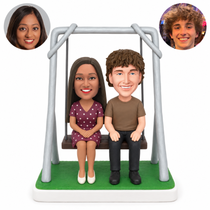 custom bobblehead figures couple sitting together on a framed swing