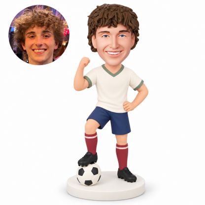 custom bobblehead figure male soccer player raising one fist with his other hand on his hip and a foot on the ball MGA-AC1279