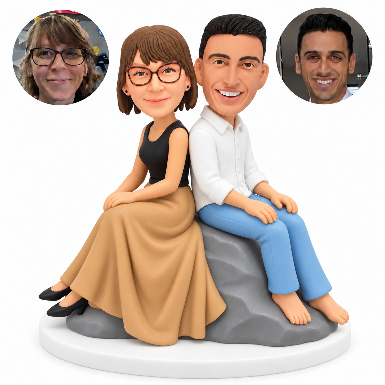 custom bobblehead figures couple seated back to back on a rock with the woman in a long skirt and the man in a shirt and jeans