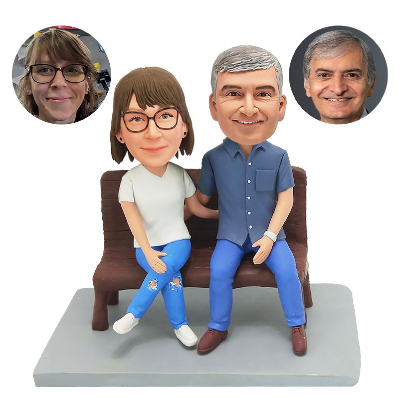 bobble head figurine couple sitting on bench