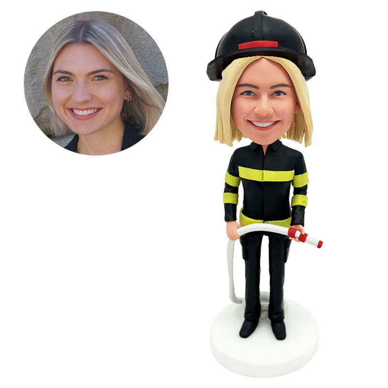 bobble head figurine firewoman holding a fire hose