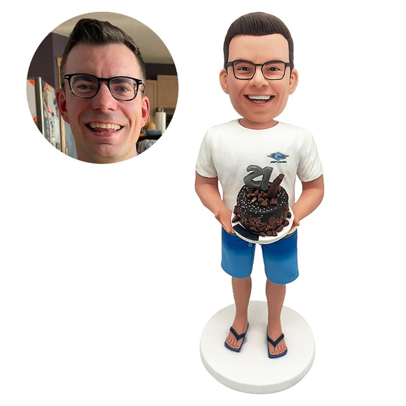 custom bobblehead figurine man holding a birthday cake with both hands