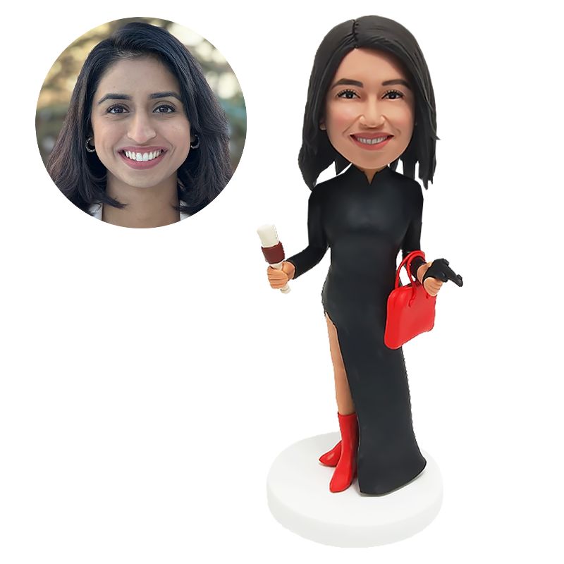 bobble head figurine lady holding a megaphone and a bag